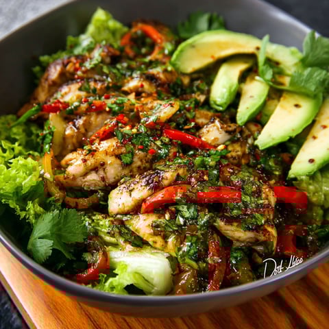A bowl of grilled chili lime chicken fajita salad.