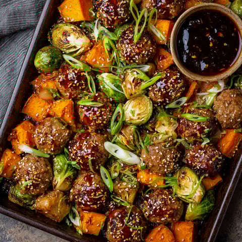 A pan of Korean BBQ meatballs and vegetables.