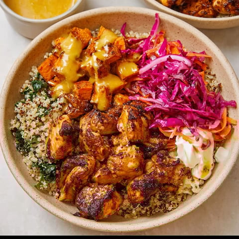A bowl of food with a variety of ingredients.