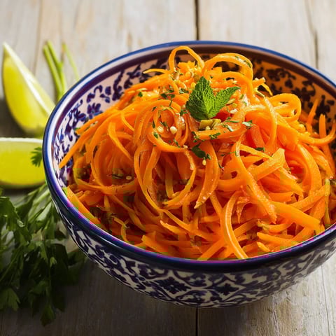 A bowl of raw carrot salad.