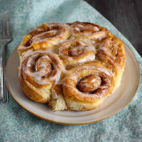 A plate of peach pie cinnamon rolls.