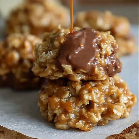 A stack of cookies with chocolate drizzled on top.
