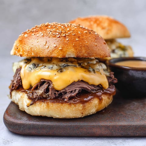 A close up of a beef and cheese burger.